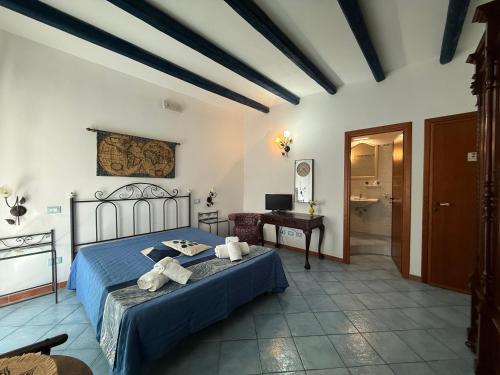 a bedroom with a blue bed and a desk at Hellas Makari B&B in Macari