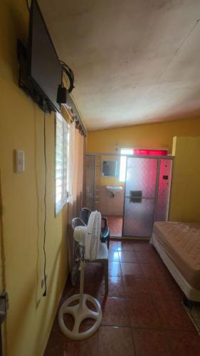 a room with a bedroom with a bed and a tv at Accommodation in Copán Ruinas #6 in Copán Ruinas
