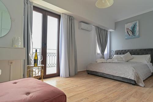 a bedroom with a bed and a large window at Galaris' Studio in Samos
