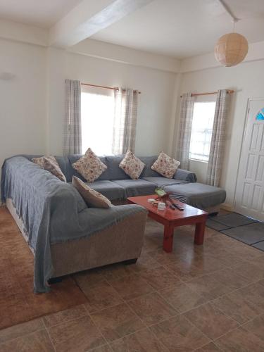 a living room with a couch and a coffee table at Fijay Bay Inn in Carriacou
