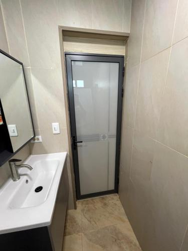 a bathroom with a shower and a white sink at Hotel Cristina in Bocas Town