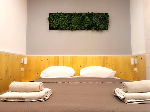a bedroom with two beds with towels on them at Minuetto 60 in Ostuni