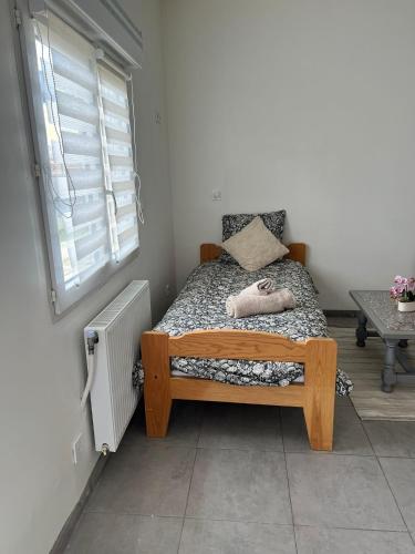 a small bed in a room with a window at studios N5 in Le Mans