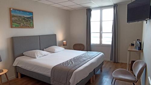 a bedroom with a bed and a large window at Notre Dame Du Laus in Saint-Étienne-le-Laus