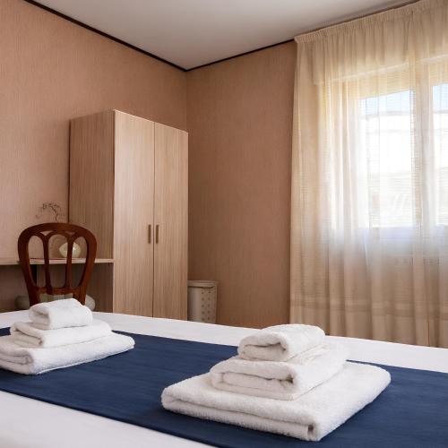 a room with a bed with towels on it at ELIOS Grand Apartment in Tropea