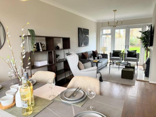 a living room with a table with wine glasses on it at Spacious house for 7 - Ideal for Solihull NEC - Work and Family Groups in Birmingham