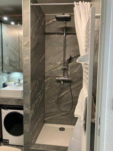 a bathroom with a shower and a sink at Le Reflet du Lac in Malbuisson