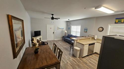 a living room with a dining table and a kitchen at Charming Condo 2min Walk From The Famous Boardwalk in Myrtle Beach