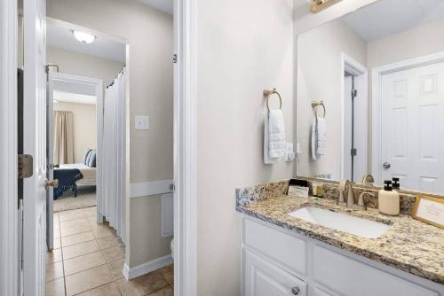a bathroom with a sink and a mirror at Aggie Game Day Walk to A&M - Kings - Outdoor in College Station