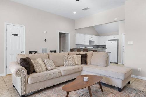 a living room with a couch and a table at Aggie Game Day Walk to A&M - Kings - Outdoor in College Station