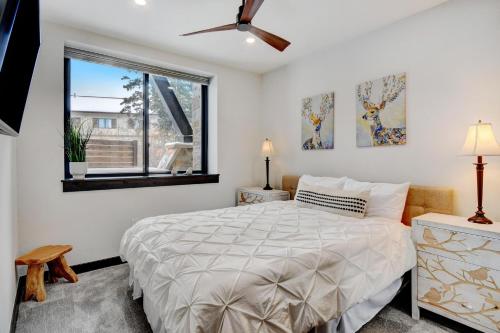 a bedroom with a bed and a window at Downtown WP River Front Villa 242 I Private Hot Tub I Great Views in Winter Park