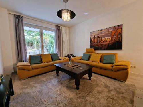 a living room with two couches and a coffee table at Helbings Apartments Essen in Essen