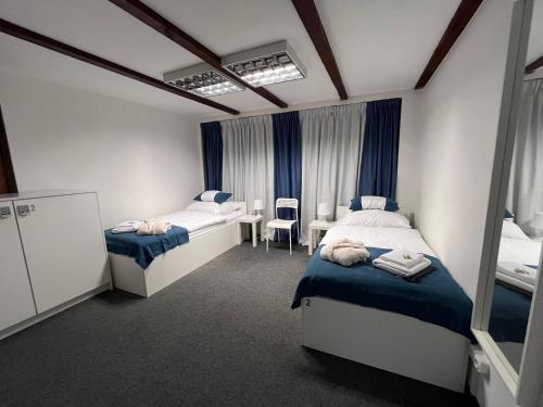 a bedroom with two beds and a table and chairs at GIRLSTEL Wrocław - Girls ONLY Space in Wrocław