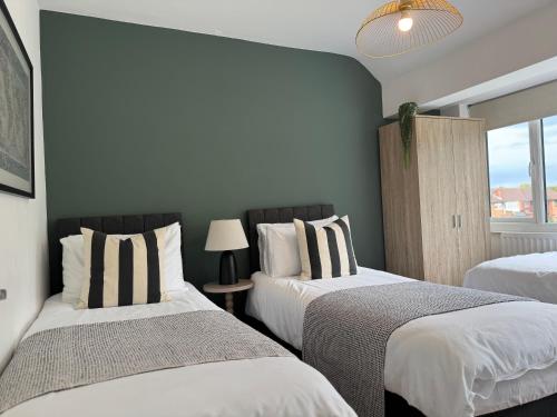 a bedroom with two beds and a window at Spacious house for 7 - Ideal for Solihull NEC - Work and Family Groups in Birmingham
