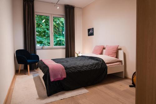 a bedroom with a bed and a window at Anubis relaxed&stay in Hamburg