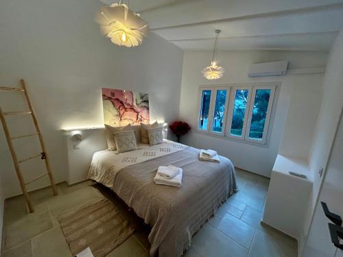 a bedroom with a bed with two towels on it at Los Caballos Villa in Cala Galdana