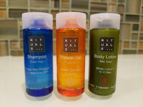 a group of four bottles of different colored liquids at Bloom! exclusive boutique b&b in Playa del Carmen