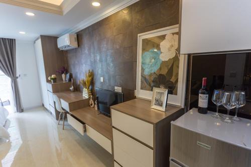 a living room with wine glasses and a television at CA&SA Serviced Apartment in Phnom Penh