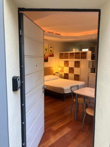 a door leading to a bedroom with a bed at Chambre indépendante in Saint-Roman