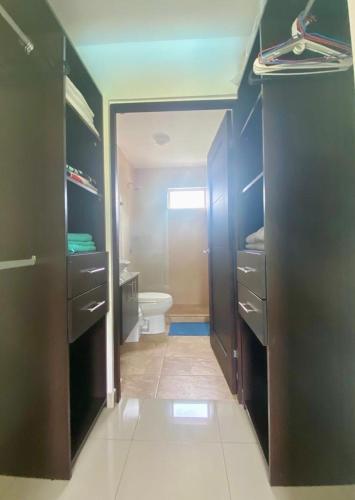 a bathroom with a toilet and a sink at Private Pool, Walk to Beach -Los Delfines in Paquera