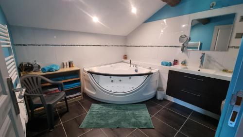 a bathroom with a tub and a sink at Gerlande 2 in Bourg-Argental