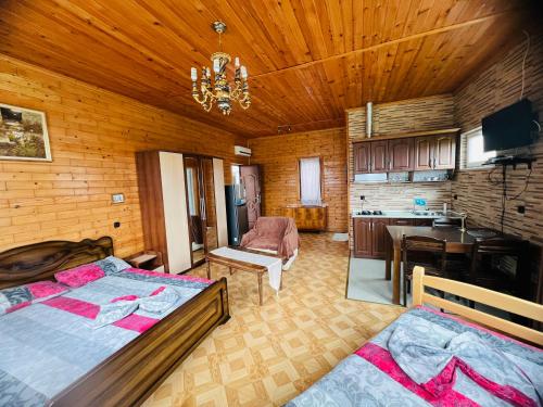 a large room with two beds and a kitchen at Hotel Roba in Ureki