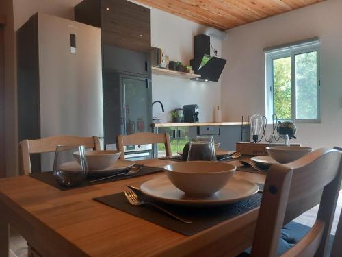 a wooden table with bowls on it in a kitchen at CdR Casa do Rei in Lajes das Flores