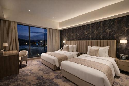 a hotel room with two beds and a window at Colombo International Airport Hotel in Katunayaka