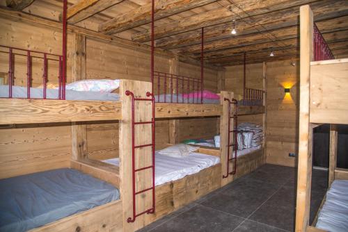 a room with three bunk beds in a cabin at Domaine de Malpas in Villers-le-Lac