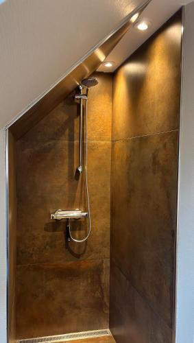 a shower stall in a bathroom with a shower at Tante Jannis Sommerpension in Bogense