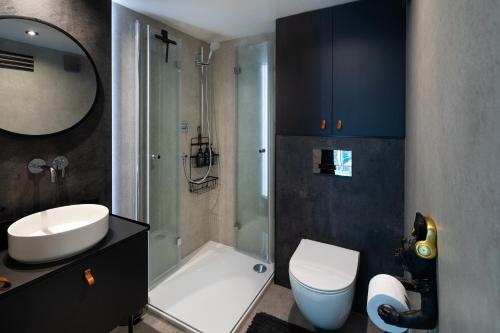 a bathroom with a toilet and a sink and a shower at Līgo glamping in Stacija Meitene