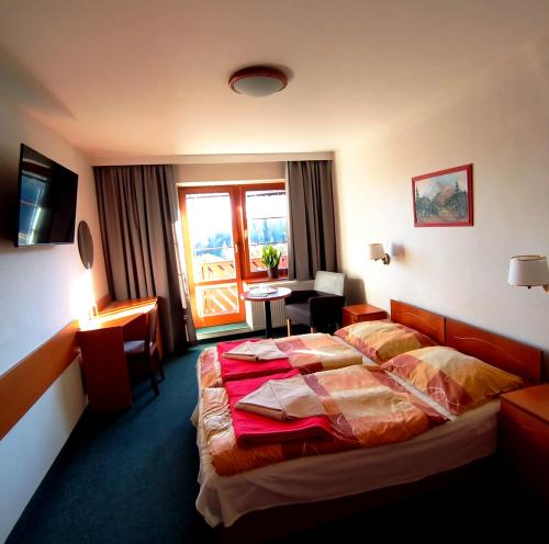 a hotel room with a bed and a window at Penzión ERIKA in Vysoké Tatry