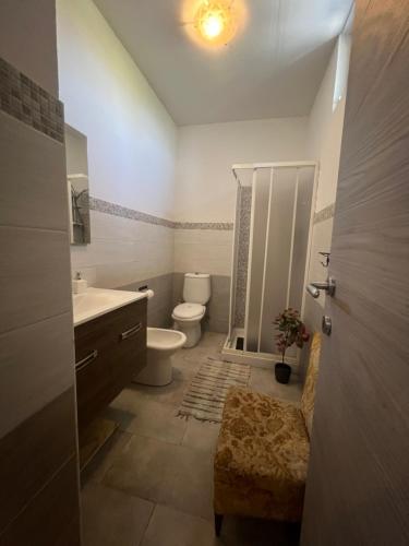 a bathroom with a toilet and a sink and a shower at Sicily Summer in Nunziata