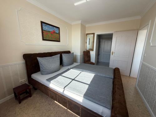 a bedroom with a large bed with blue pillows at Appartementhaus, Villa Katharina, Sassnitz in Sassnitz