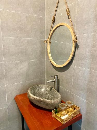 a bathroom with a sink and a mirror on a table at Bếp Thông home in Xuan An