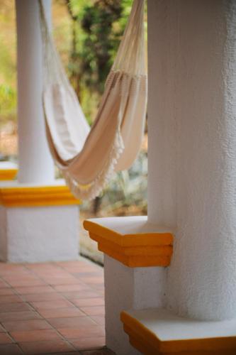 a porch with a window with a hammock at Casa Aply in San Andrés Huayapan