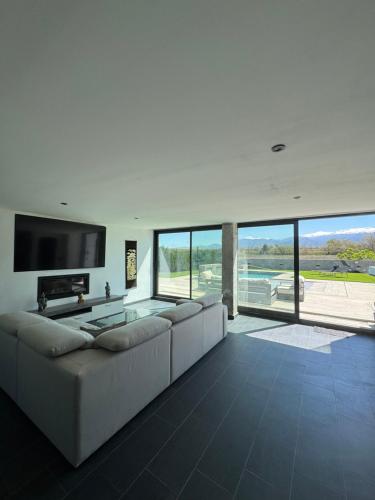 a large living room with a couch and a tv at Villa Baena in Granada