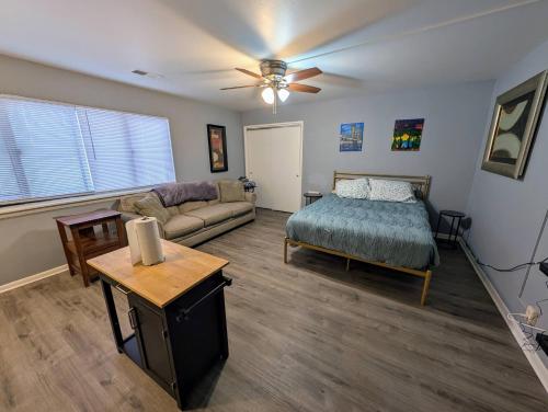 a living room with a bed and a couch at Spacious Studio near Brady St in Milwaukee