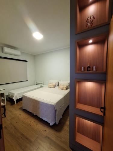 a bedroom with two beds and a chalkboard at Casa Arara in Espirito Santo Do Pinhal