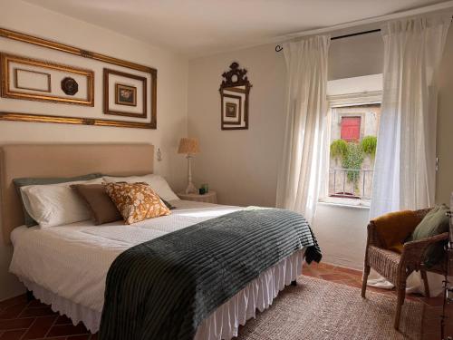 a bedroom with a bed and a window at La Casetta Di Borgo in Lajatico