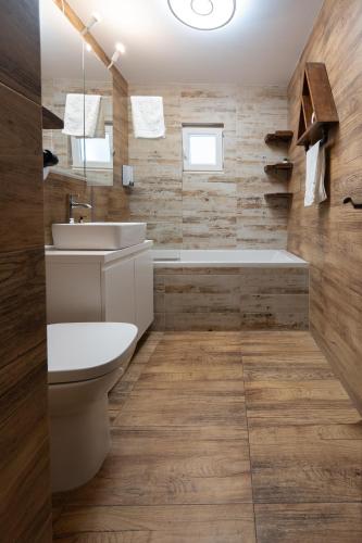a bathroom with a sink and a toilet and a tub at 3 Baneasa Airport in Bucharest