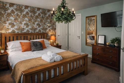 a bedroom with a bed with towels on it at The Union Inn in Cowes