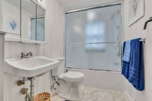 a bathroom with a toilet and a sink and a shower at Cornish Cottage Walk to Long Sands Beach in York