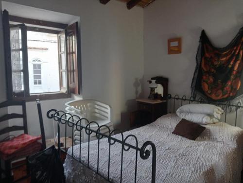a bedroom with a bed and a window at Ferreira do Alentejo Terrace Rustic Villa in Beja