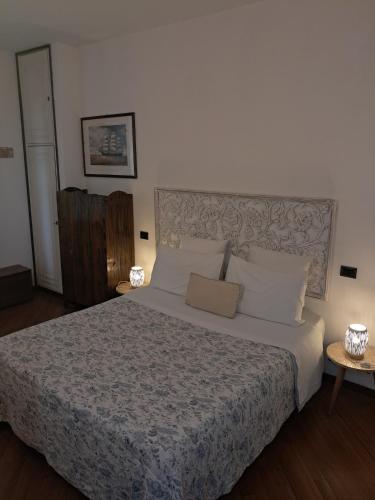 a bedroom with a large bed with white pillows at Terrazza Miracapri in Pozzuoli