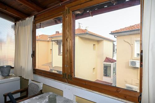 a window in a room with a view of a building at Calm Breeze House in Nea Peramos