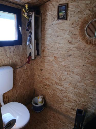 ein kleines Badezimmer mit Toilette und Fenster in der Unterkunft Max in Bihać