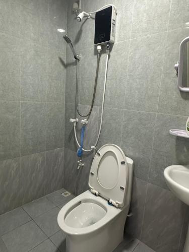 a small bathroom with a toilet and a shower at The friendly stay in Male City