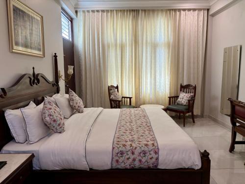 a bedroom with a large bed in a room at Chitawa Haveli A Luxury Heritage Hotel in Jaipur