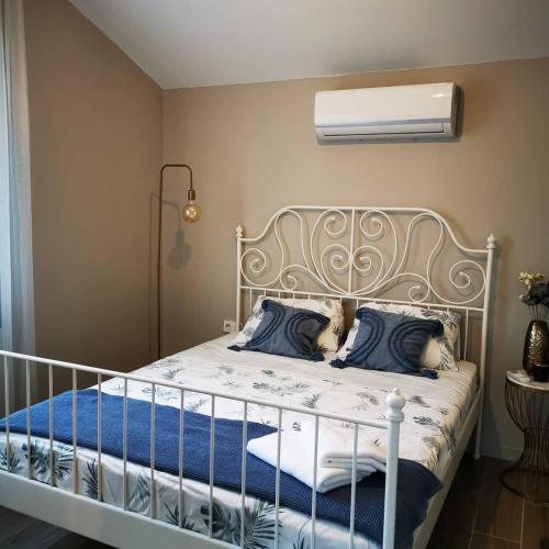 a bedroom with a white bed with blue pillows at Villa Rüzgar in Dalaman
